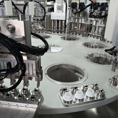 Customised carousel type milk cap assembling machine with feeding by means of a loading machine can reduce the manual dumping time and improve the operation rate of the machine.